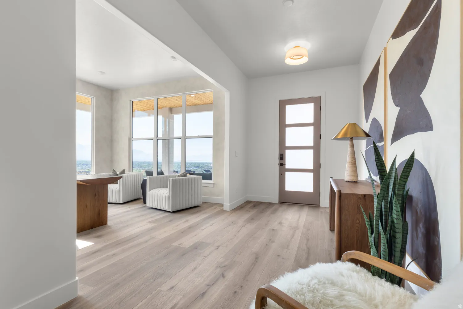 Foyer entrance featuring light wood-style floors and healthy amount of natural light
