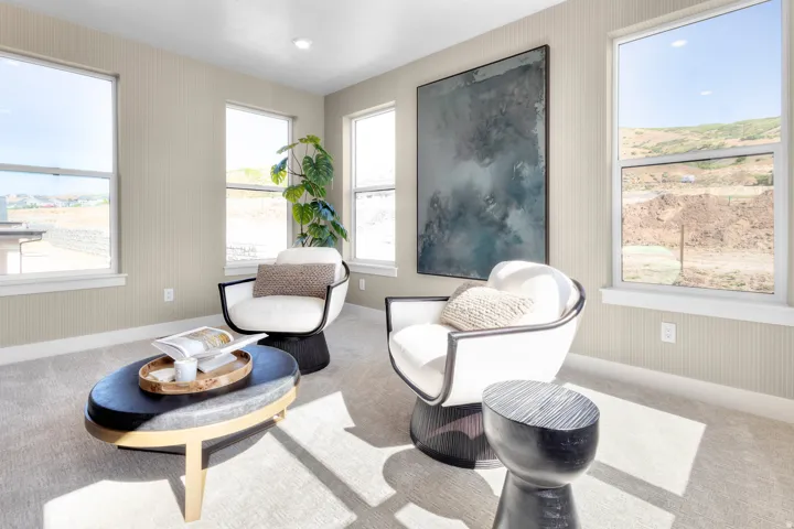 Living area with baseboards and carpet