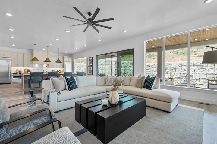 Living area with light wood-style flooring, recessed lighting, and a ceiling fan
