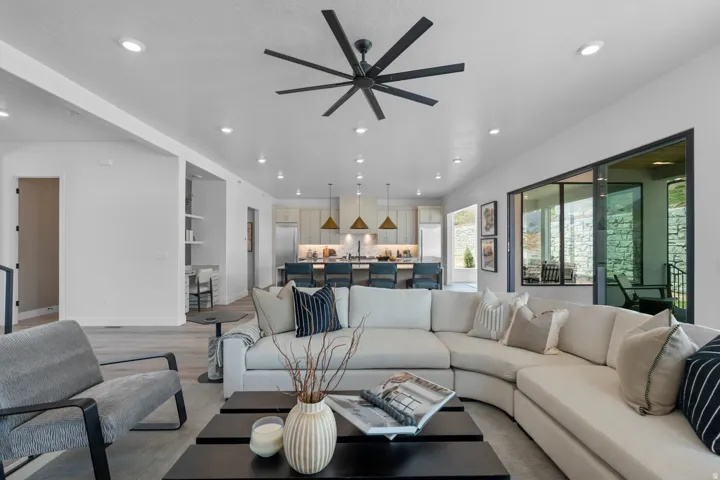 Living area with light wood finished floors, recessed lighting, and a ceiling fan