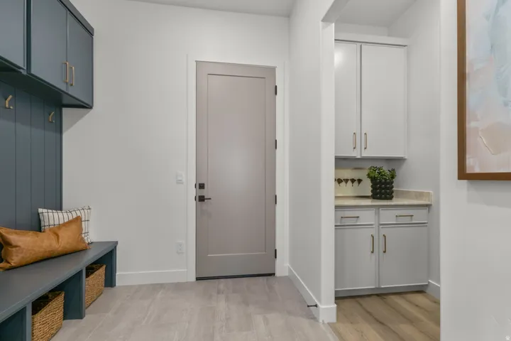 Mudroom with baseboards and light wood-style flooring