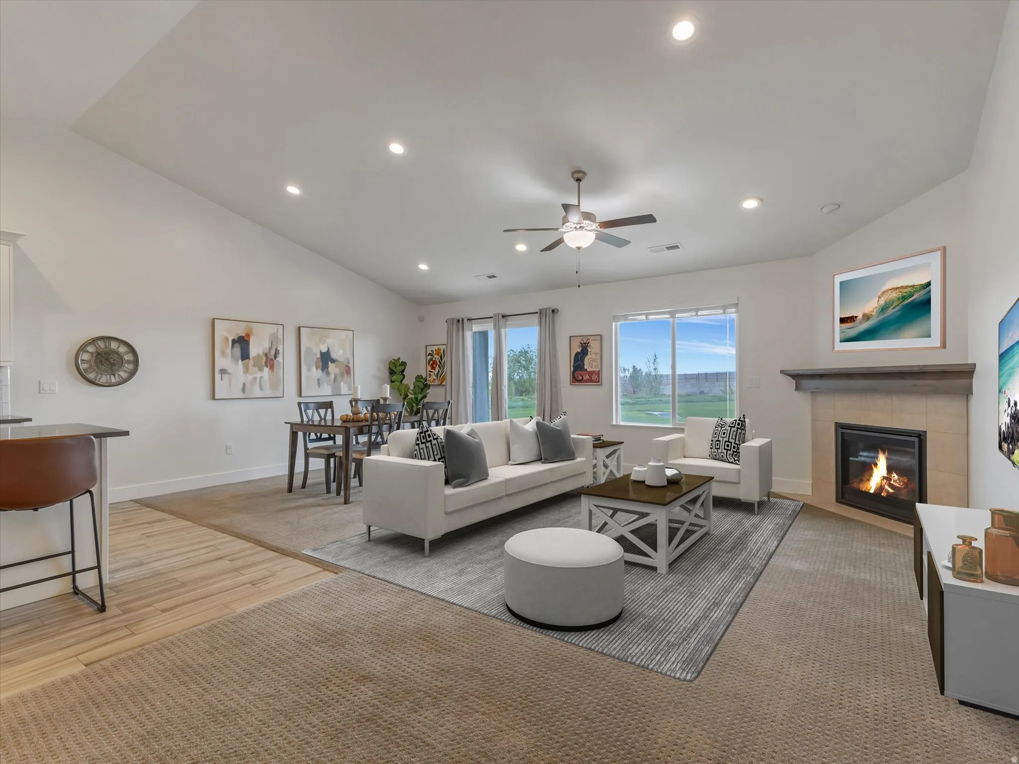 Living area with a fireplace, lofted ceiling, a ceiling fan, light colored carpet, and recessed lighting