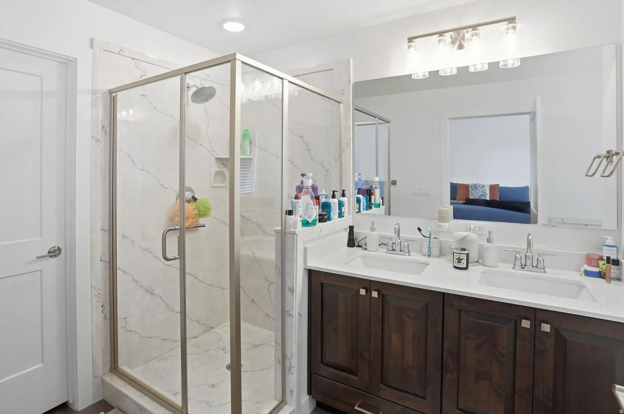 Full bathroom featuring double vanity, a marble finish shower, and ensuite bath