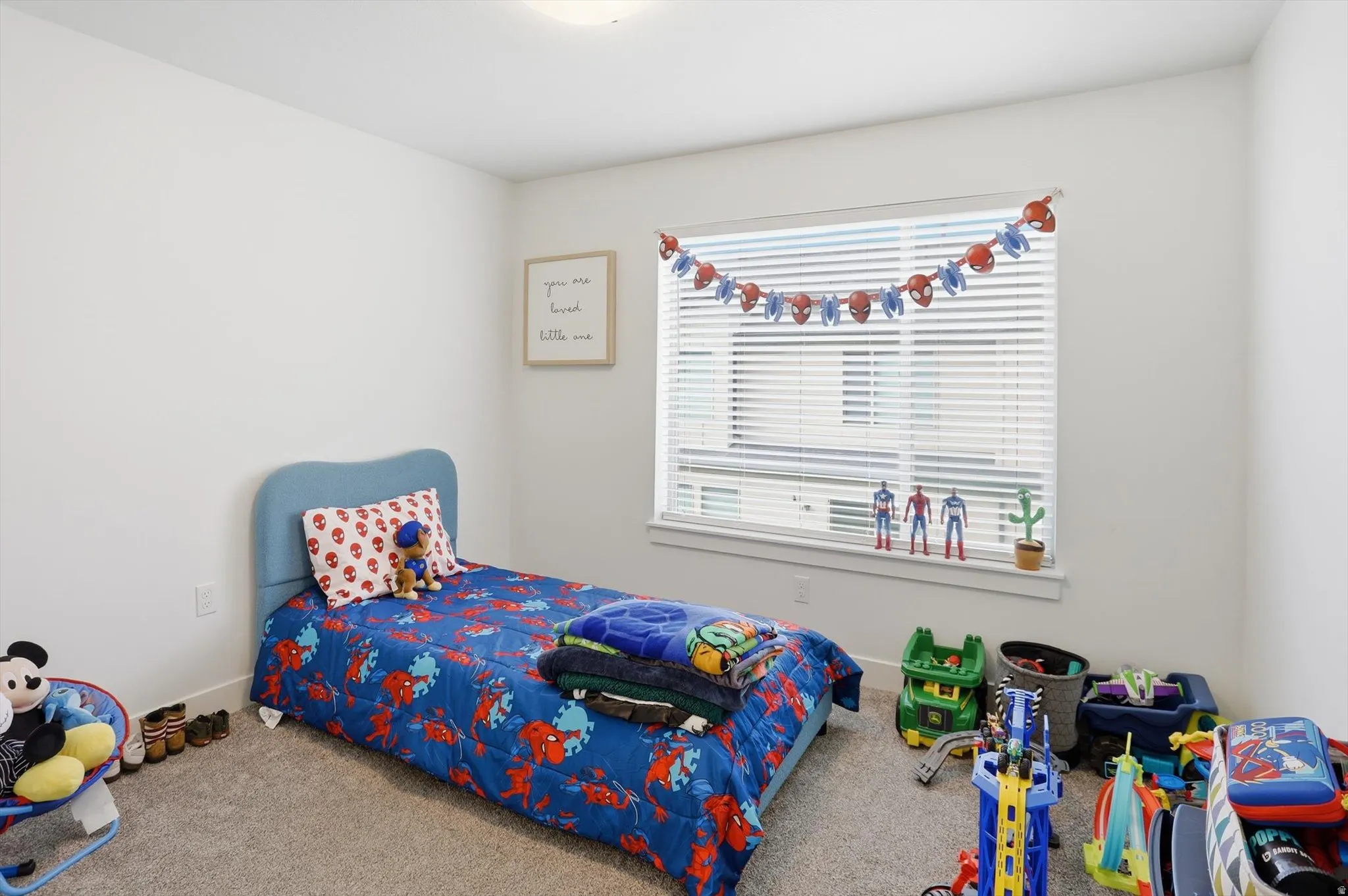 Carpeted bedroom featuring baseboards
