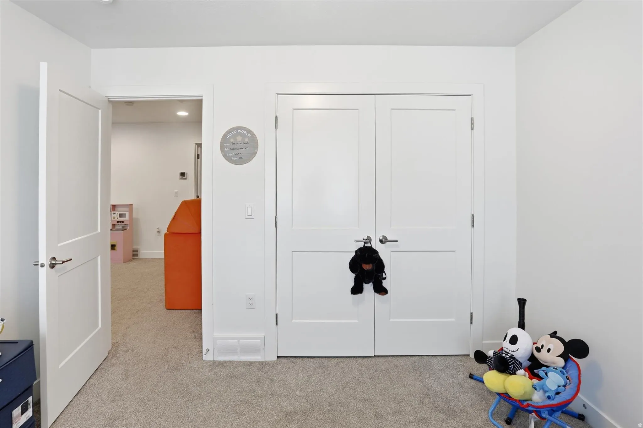 Unfurnished bedroom with light carpet and a closet