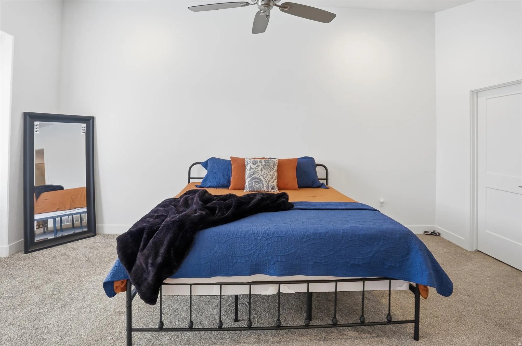 Bedroom featuring light carpet and a ceiling fan