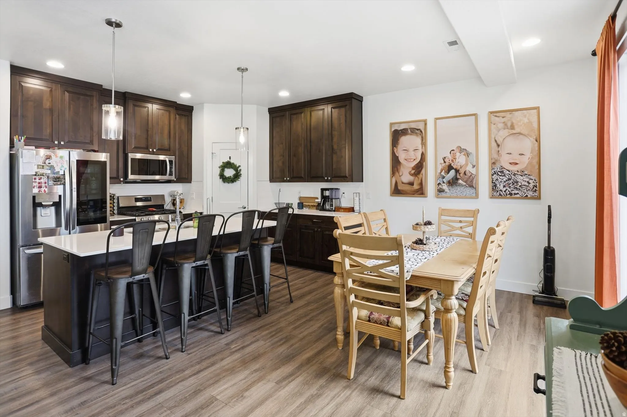 Dining area with light wood-style flooring and recessed lighting