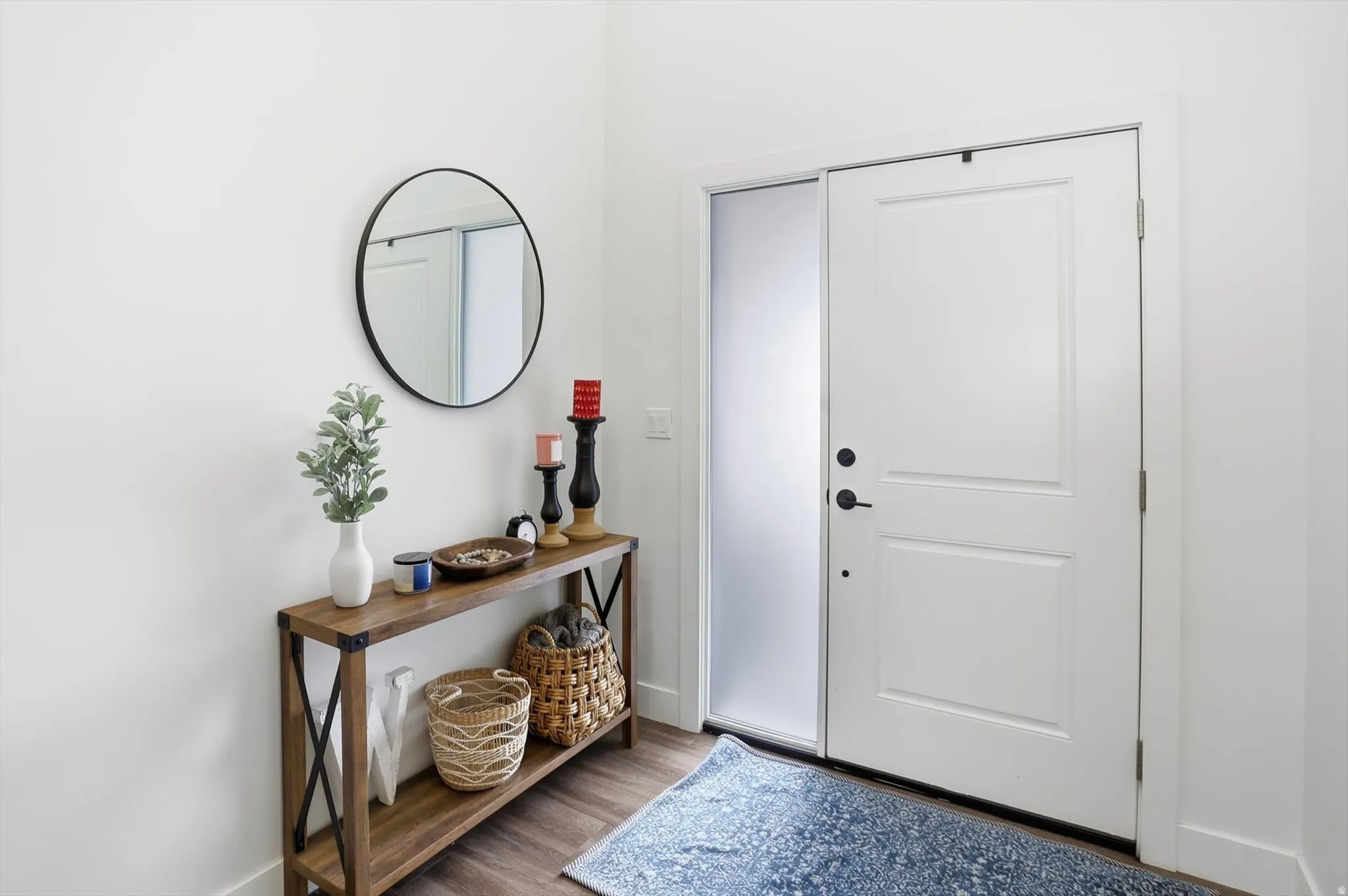 Foyer featuring baseboards and dark wood-style flooring