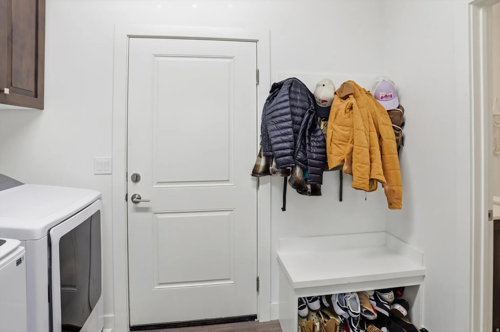 Laundry area with cabinet space and washing machine and clothes dryer