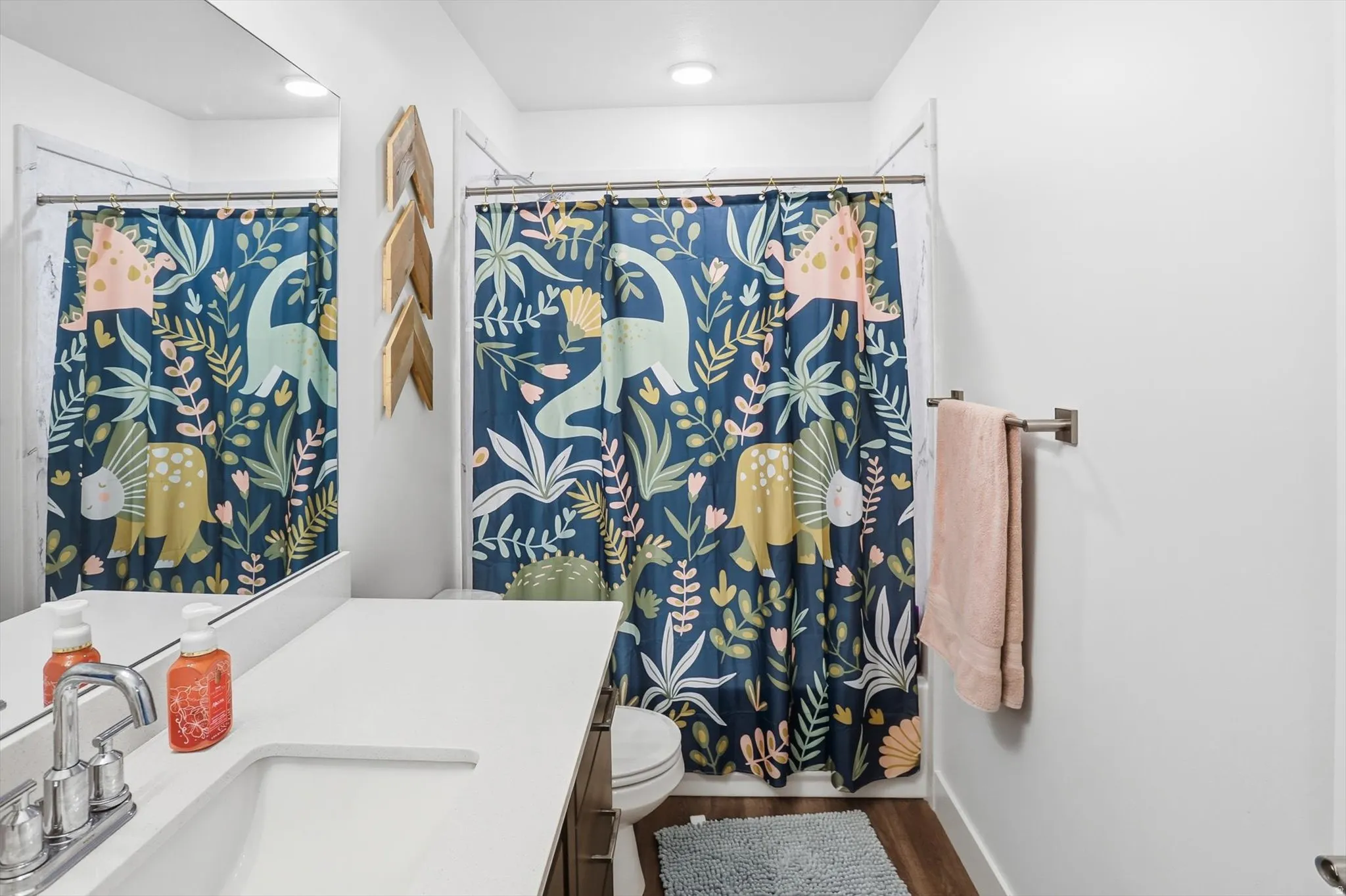 Bathroom with vanity and dark wood-style flooring