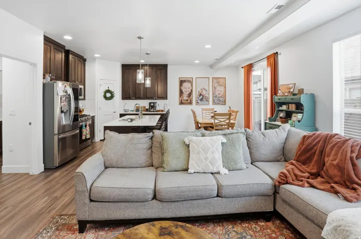Living room with recessed lighting and dark wood-style floors