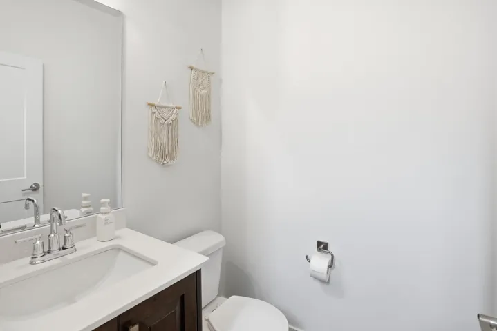 Half bathroom featuring vanity and toilet