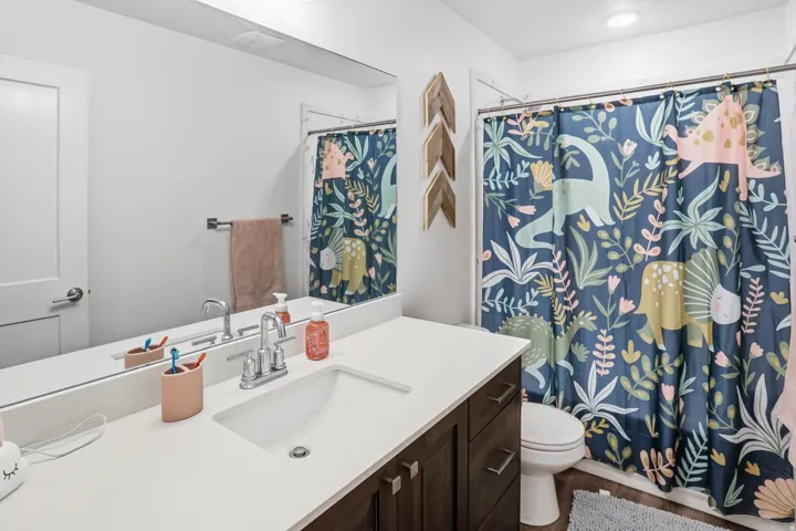Bathroom featuring vanity and curtained shower