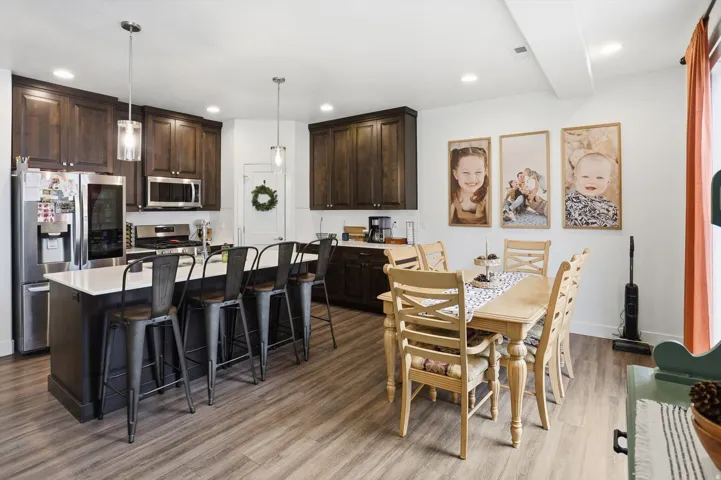 Dining area with light wood-style flooring and recessed lighting