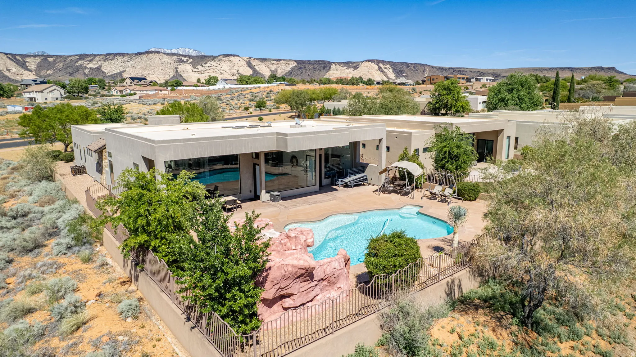 Rear view of house with a patio area, a mountain view, and stucco siding