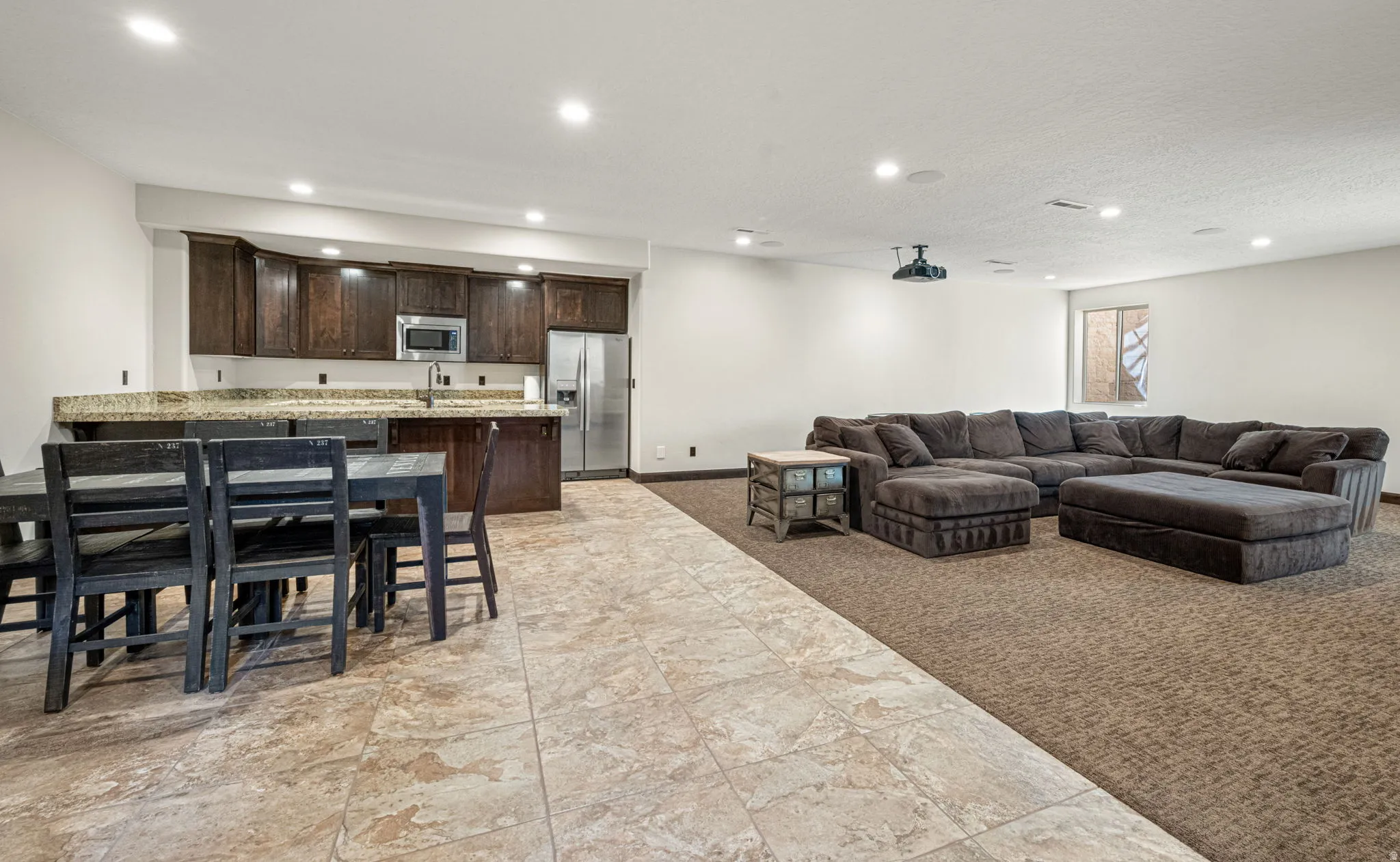 Living room featuring light carpet, recessed lighting, and a textured ceiling