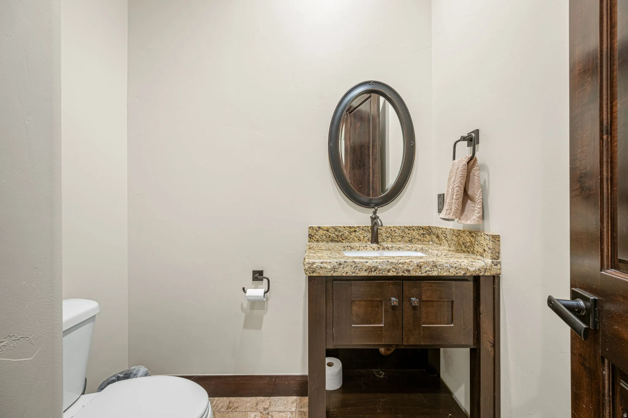 Half bathroom with toilet and vanity