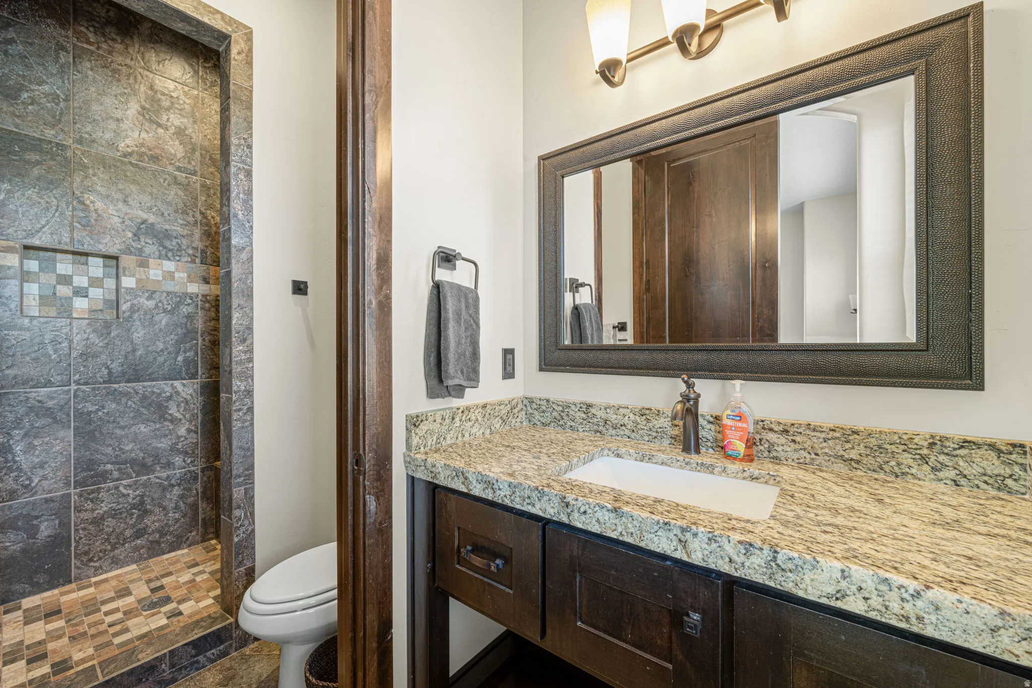 Bathroom with vanity and a shower stall