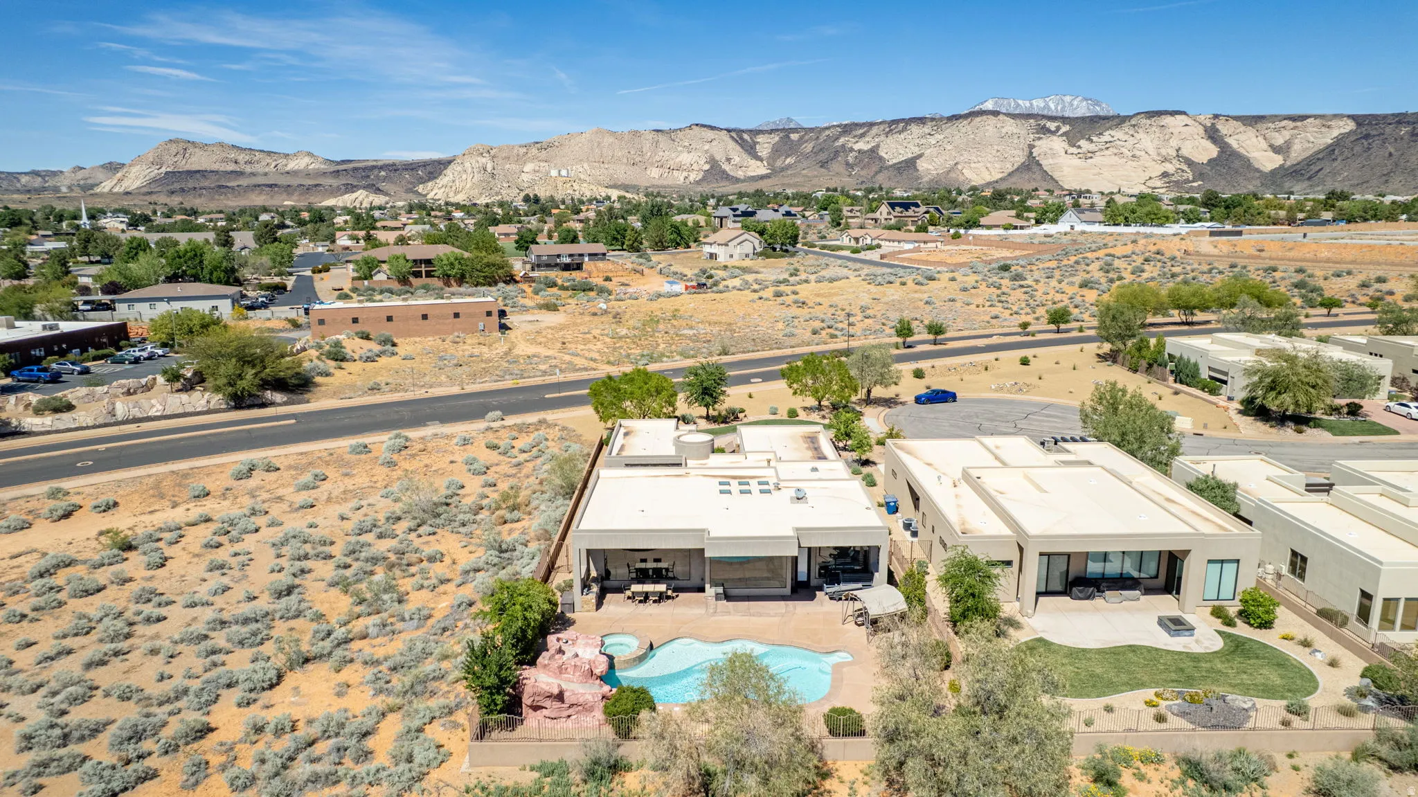 Aerial view of residential area with mountains and a pool area