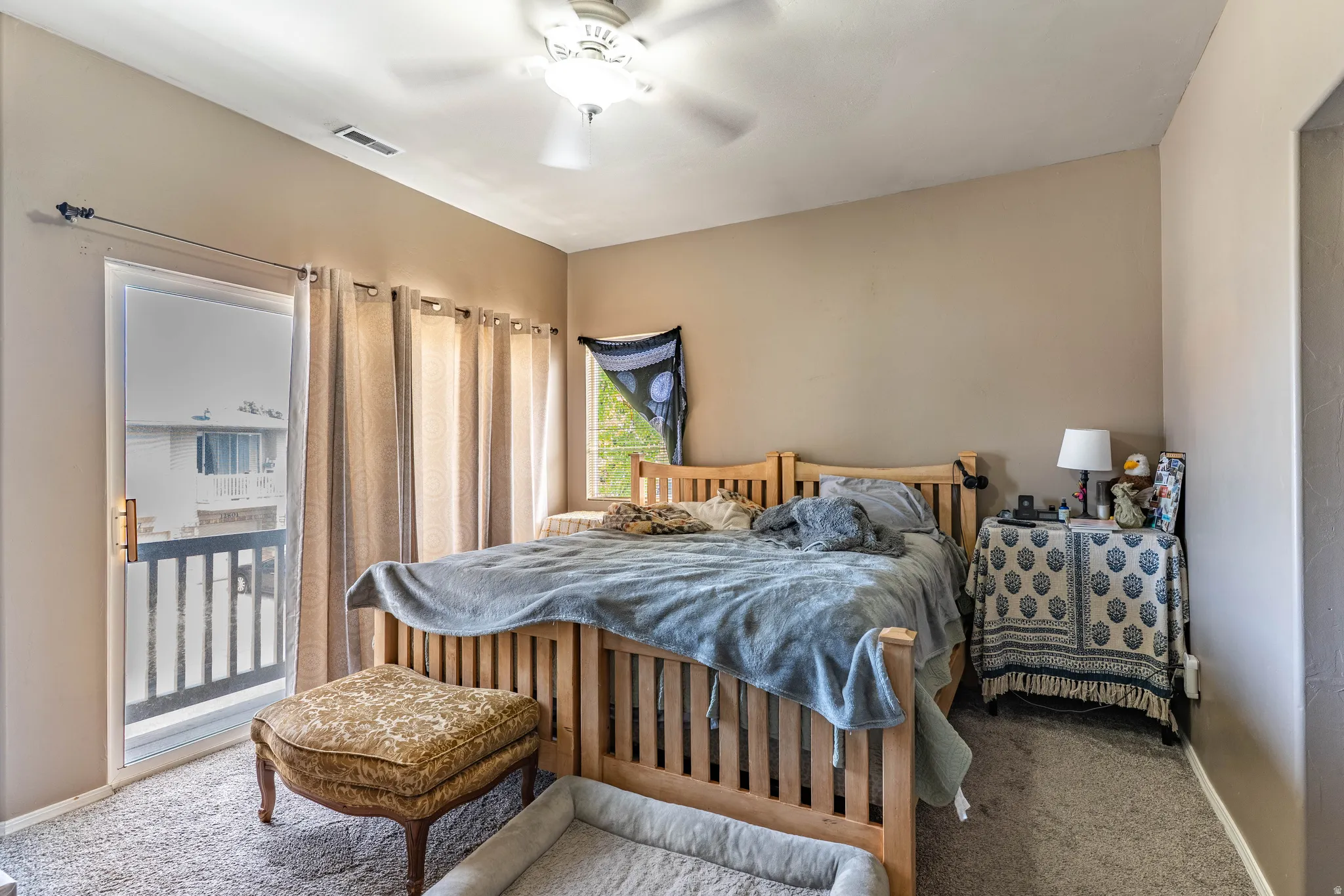 Carpeted bedroom featuring baseboards and ceiling fan