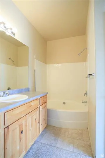 Bathroom with vanity and shower / tub combination