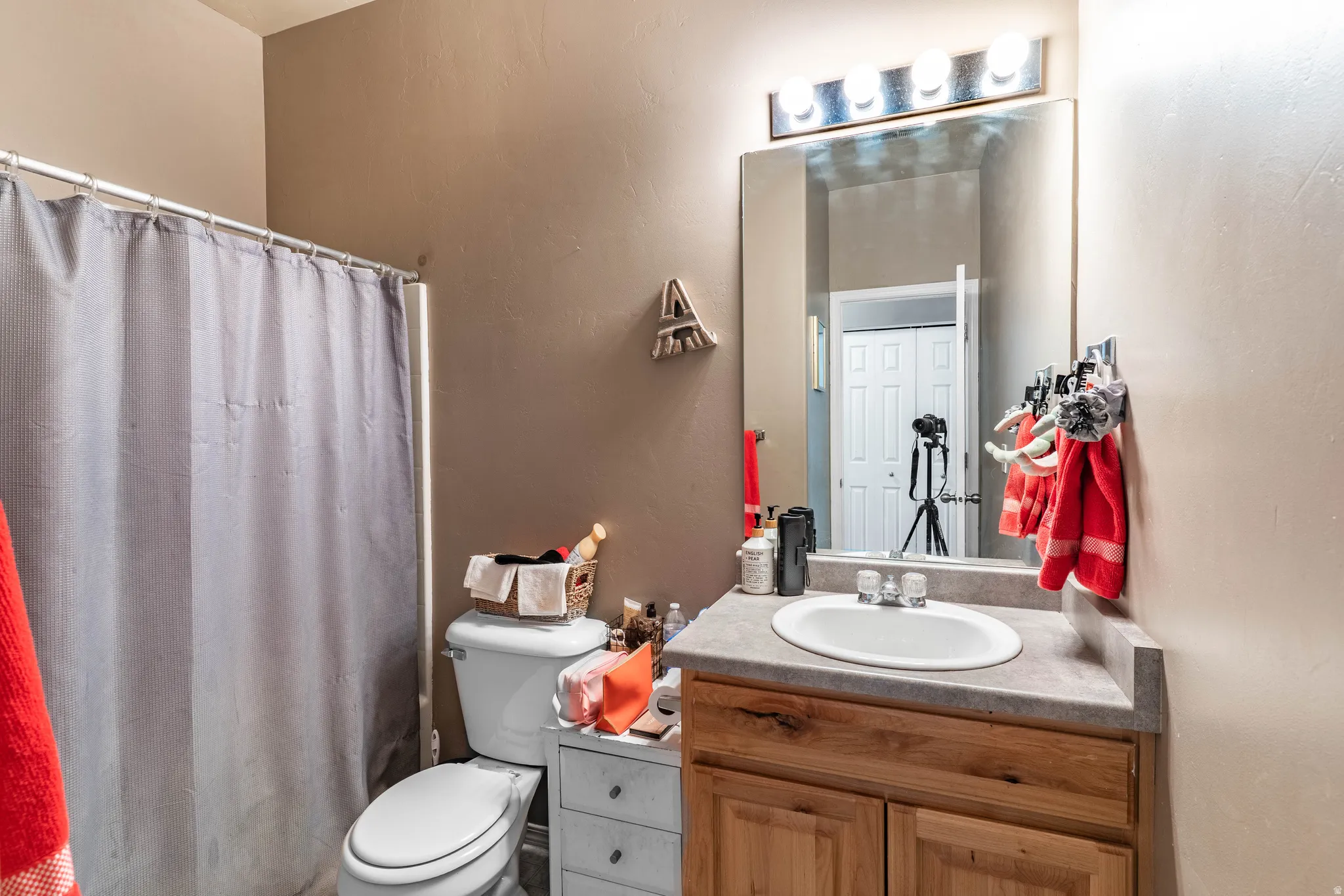 Bathroom with vanity and a shower with shower curtain