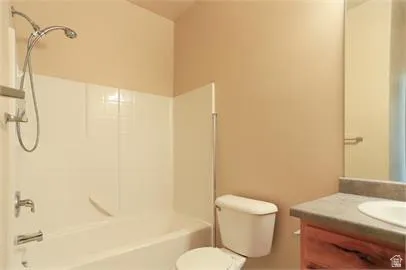 Full bath featuring vanity and washtub / shower combination