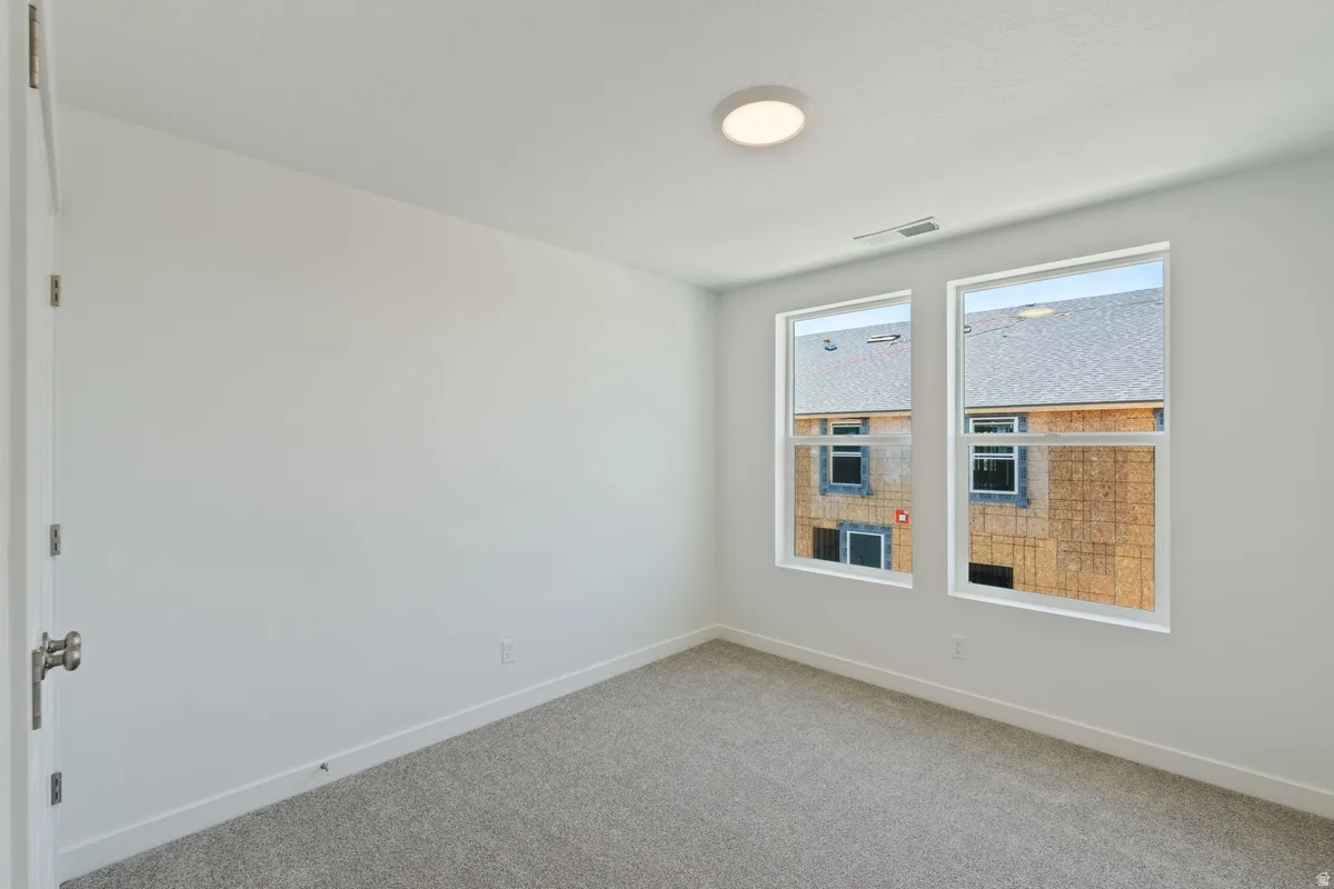 Unfurnished room featuring baseboards and carpet flooring