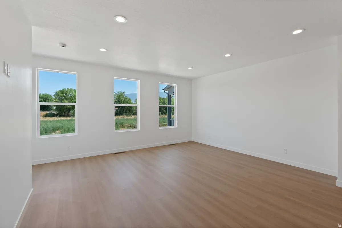 Spare room with light wood-style floors and recessed lighting