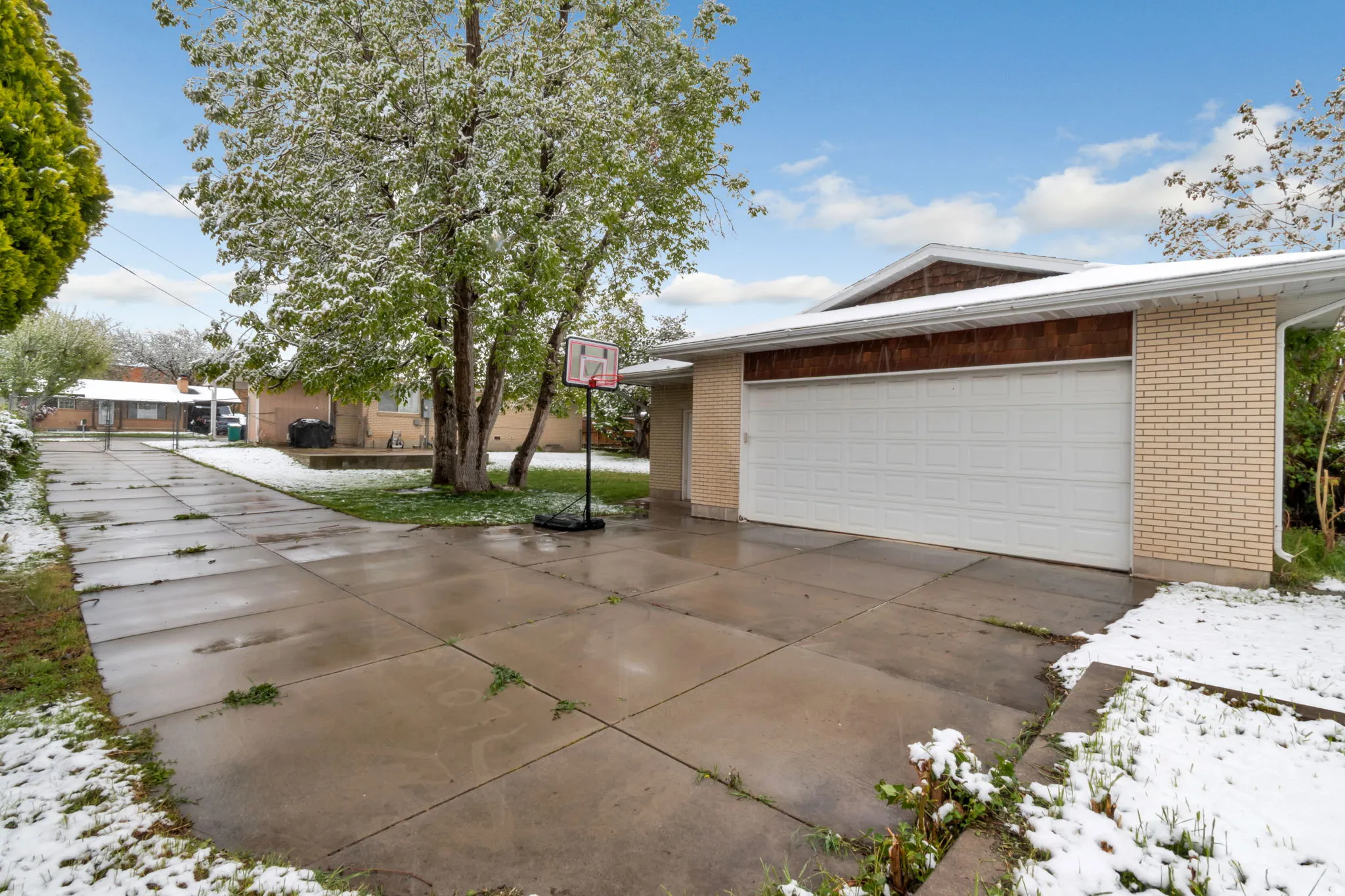 Ranch-style house featuring brick siding, driveway, and an attached garage
