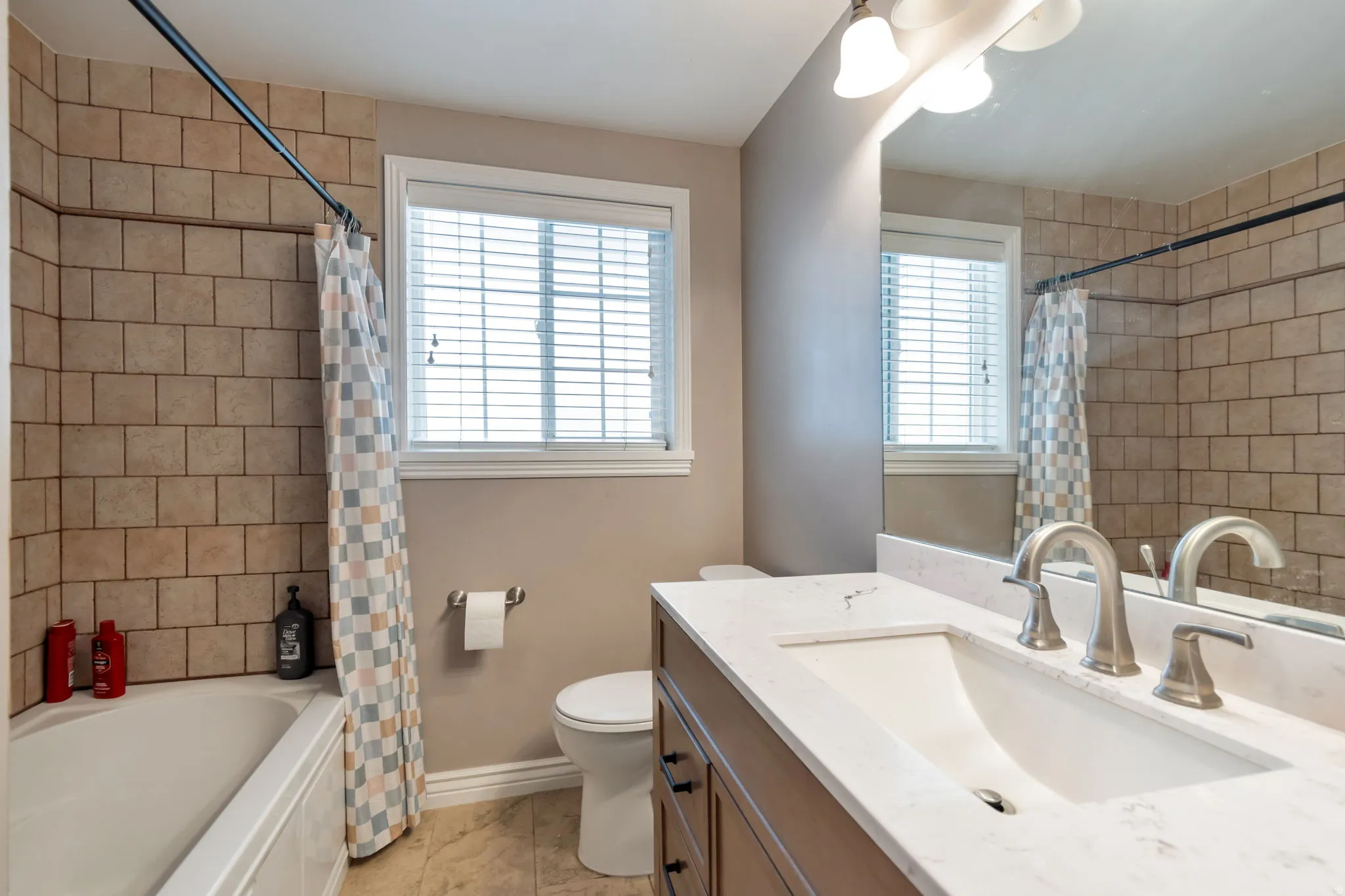 Bathroom with vanity and shower / bath combo