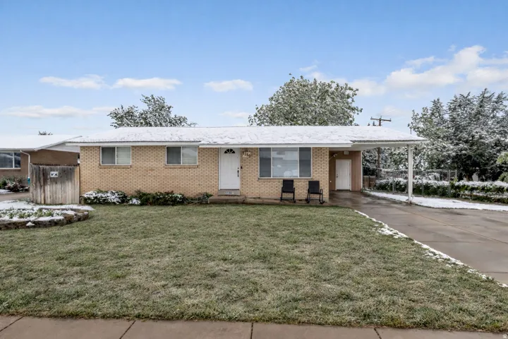 Single story home with a carport, concrete driveway, and brick siding