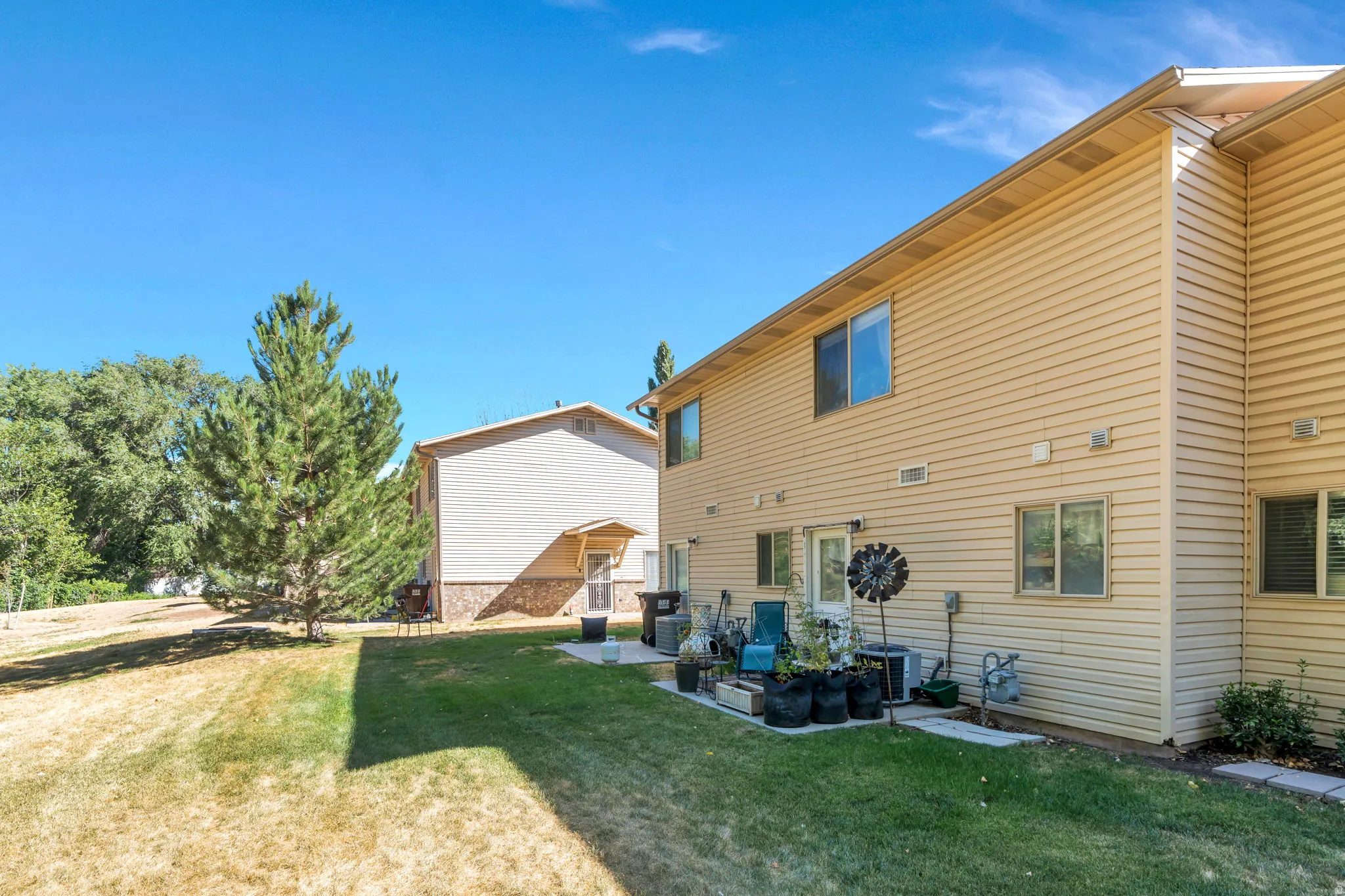 Rear view of house featuring a lawn and a patio area