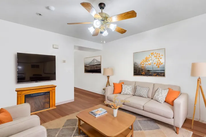 Living room with gas fireplace, digitally staged
