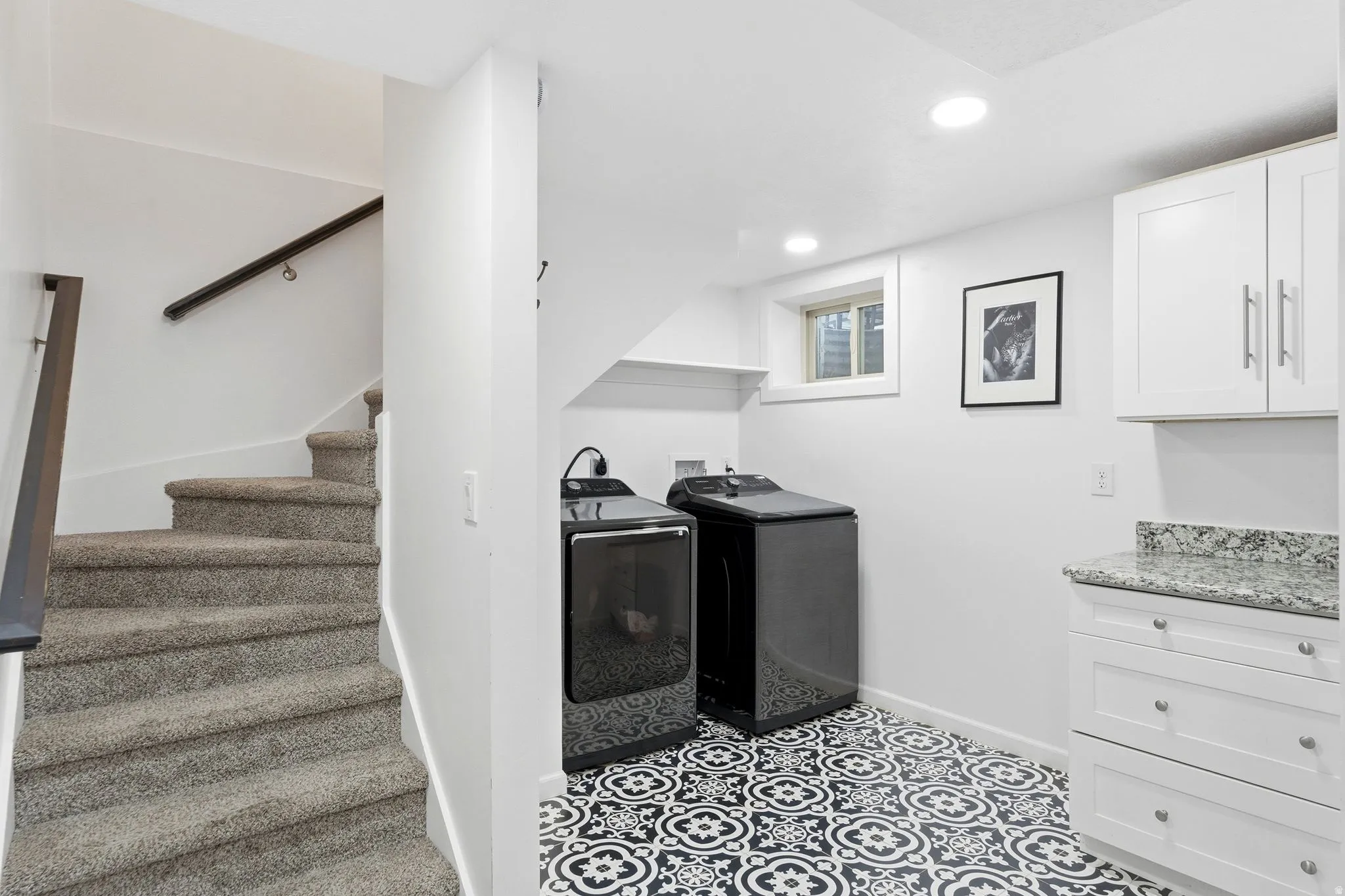 Laundry room featuring separate washer and dryer, recessed lighting, and cabinet space