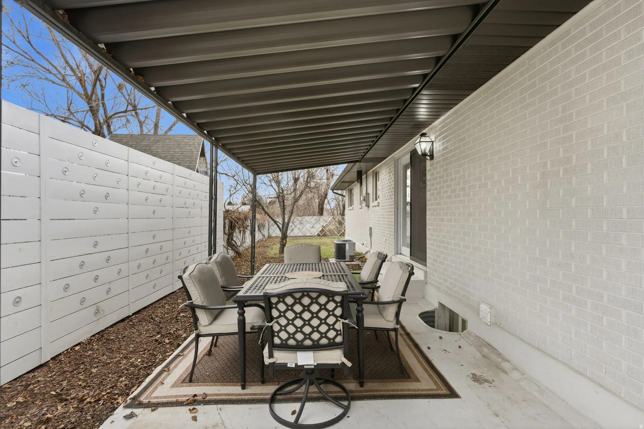 Fenced backyard featuring outdoor dining area and a patio