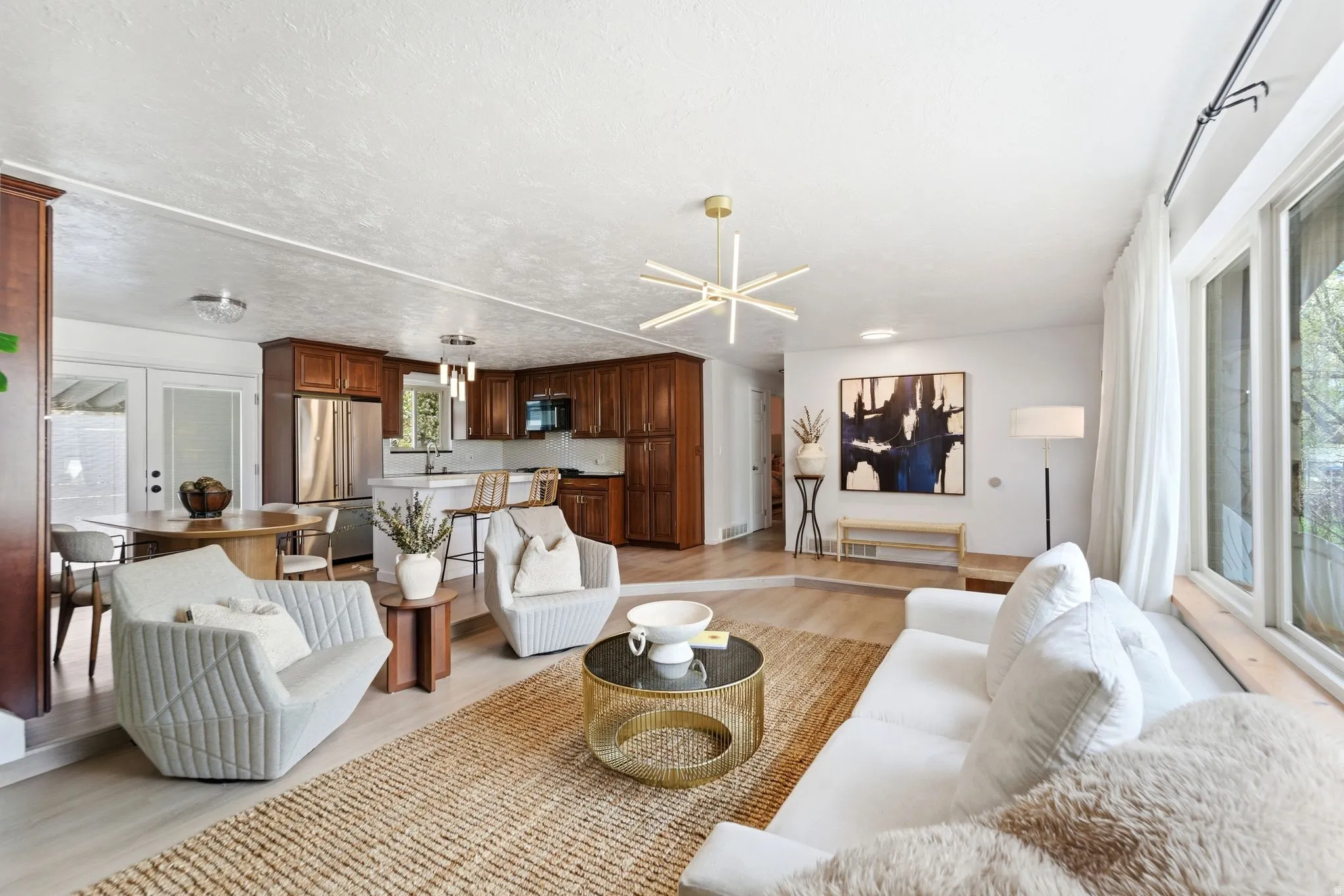 Living room featuring light wood-style floors and a textured ceiling