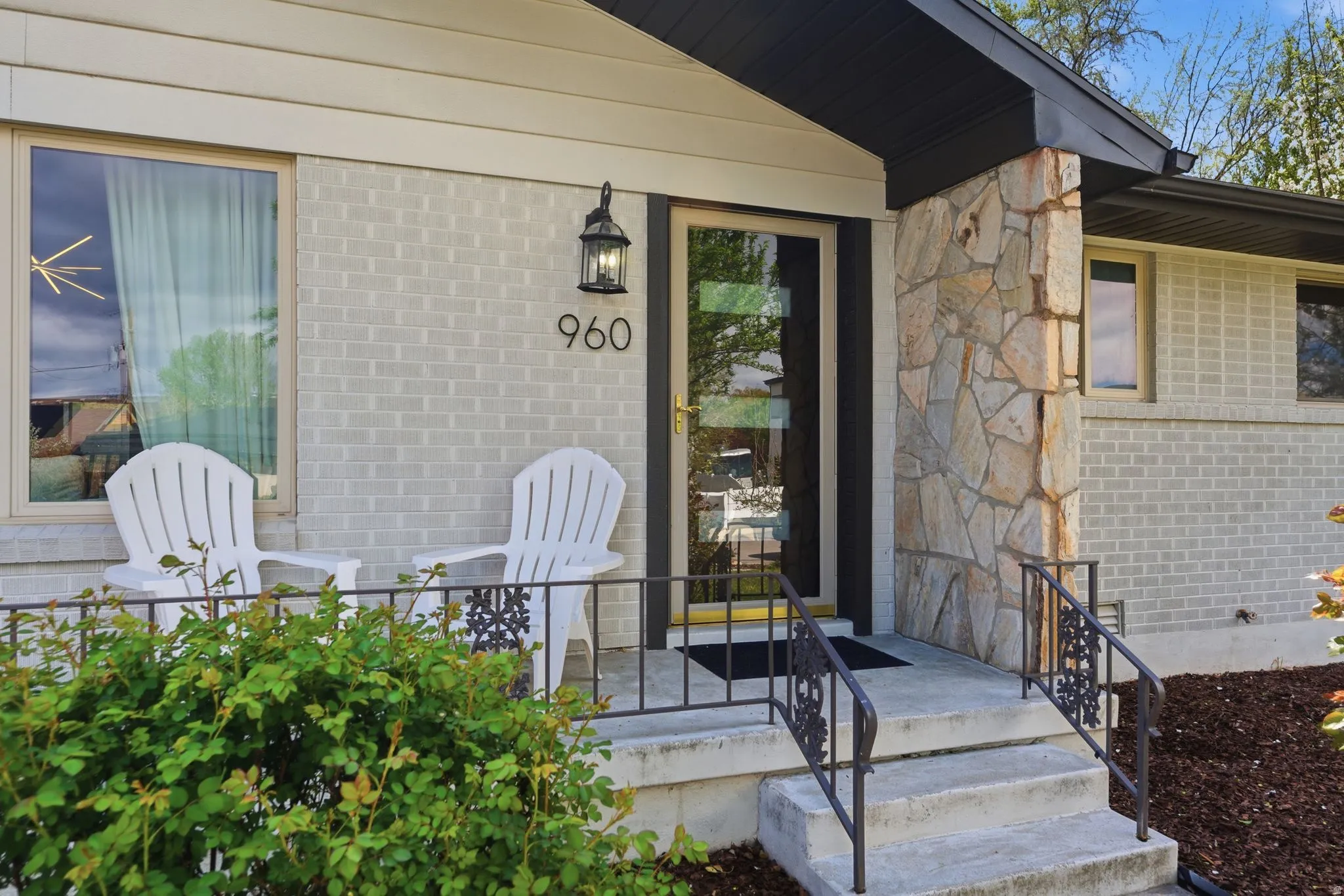 Doorway to property featuring brick siding and stone siding