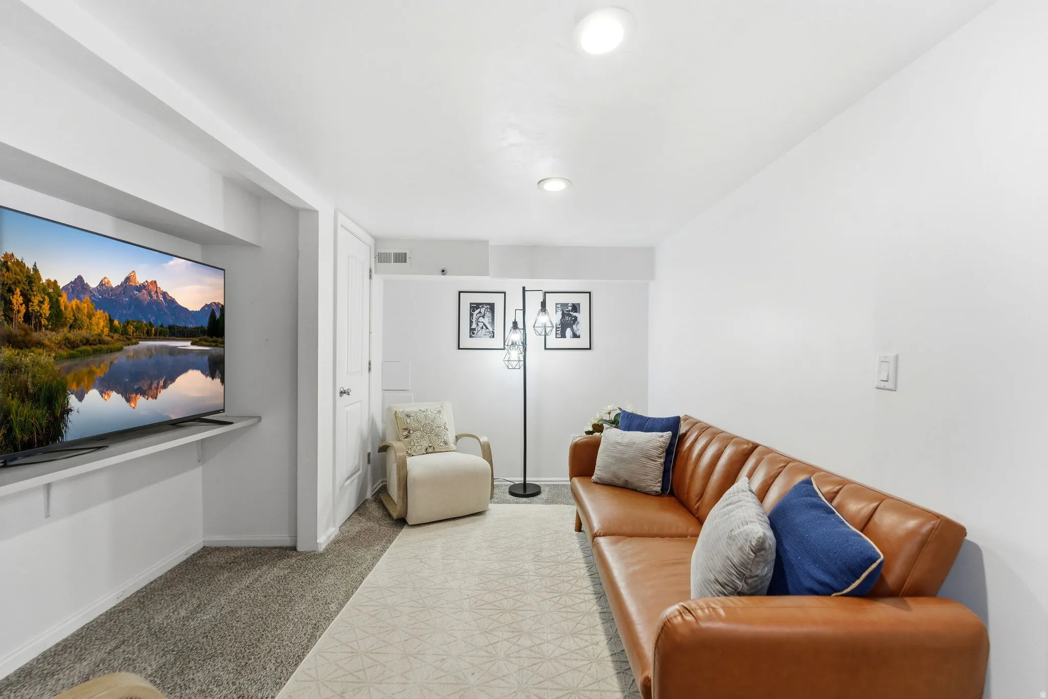 Living room with light colored carpet and baseboards
