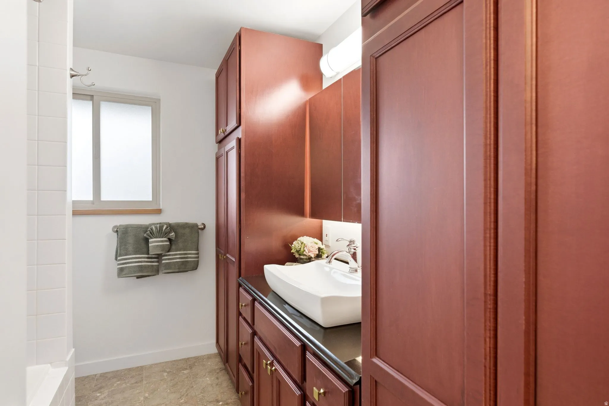 Full bath featuring vanity and baseboards