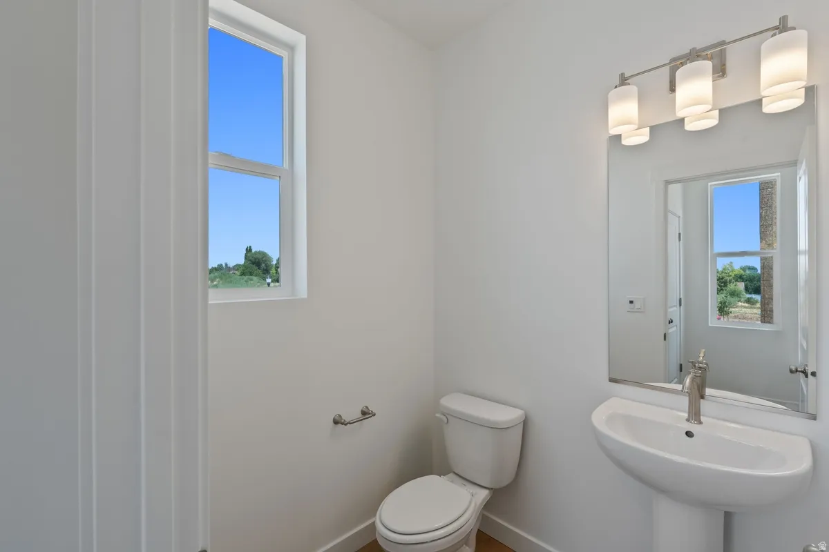 Bathroom with toilet and baseboards