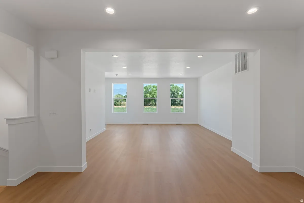 Spare room with light wood-style floors and recessed lighting