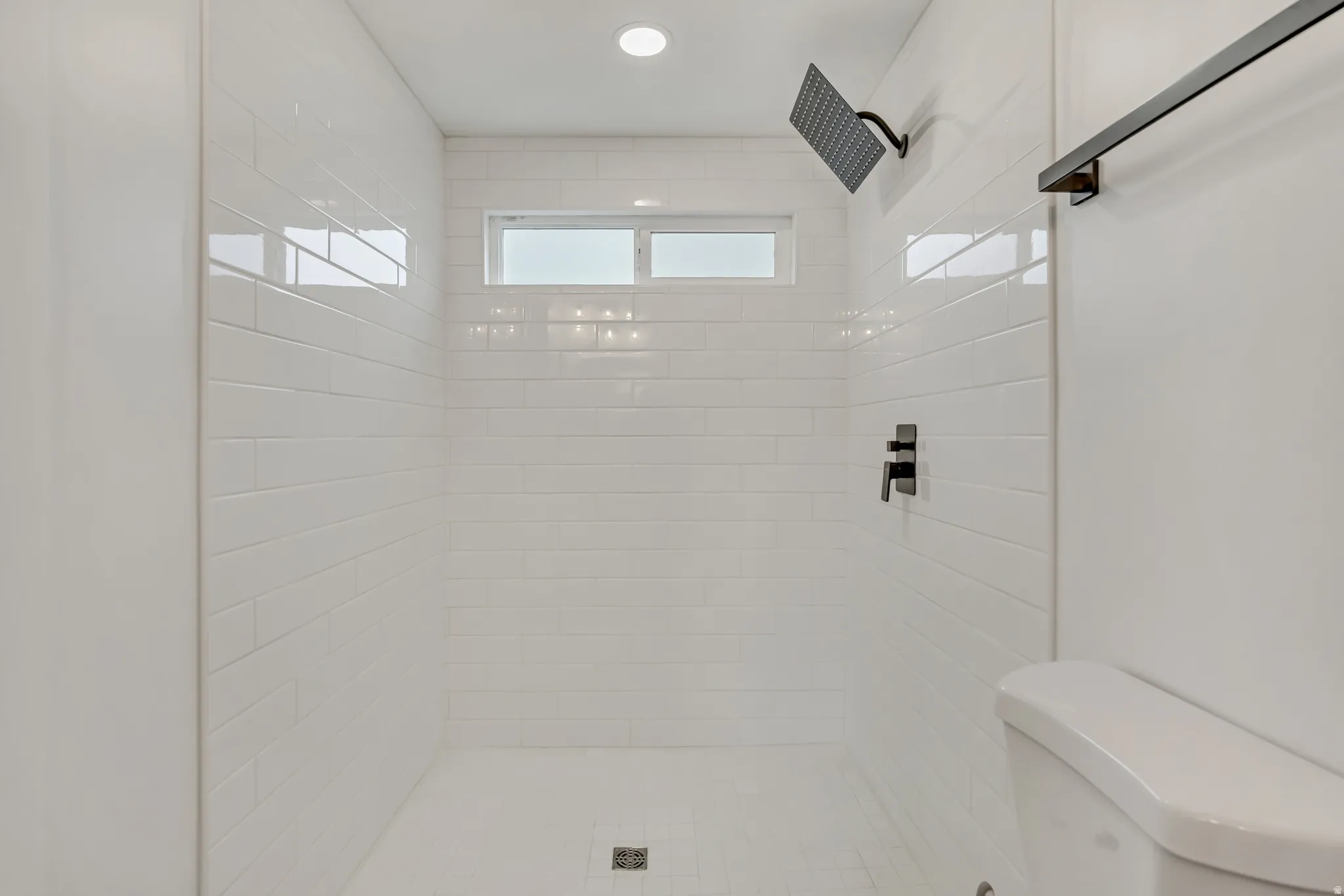 Full bathroom with toilet and a stall shower