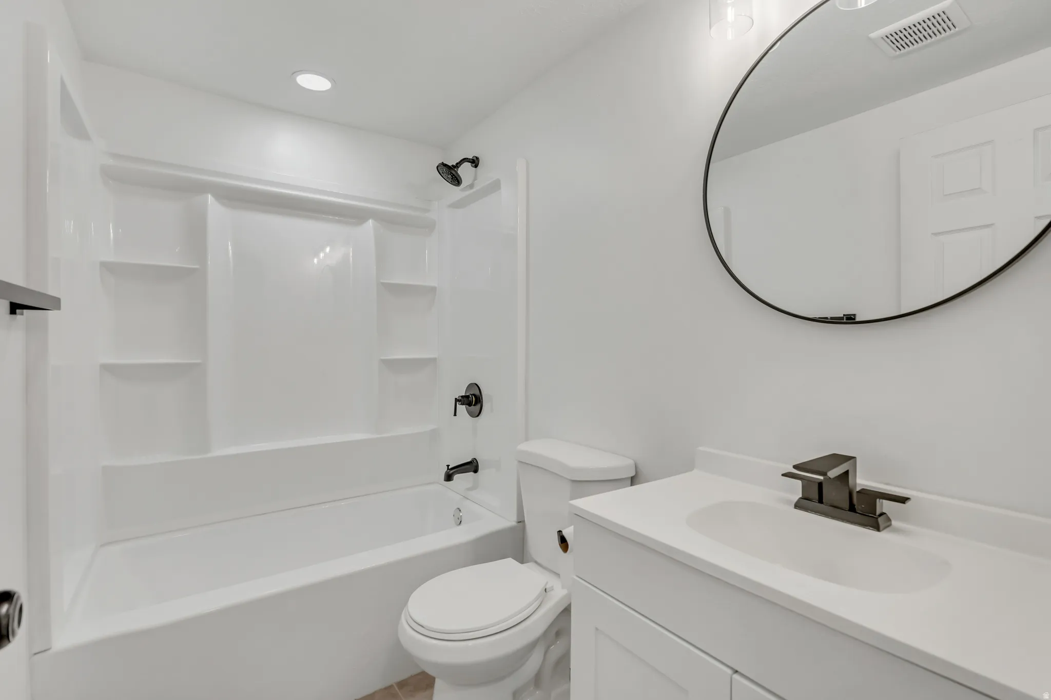 Bathroom with vanity, shower / bathtub combination, and recessed lighting