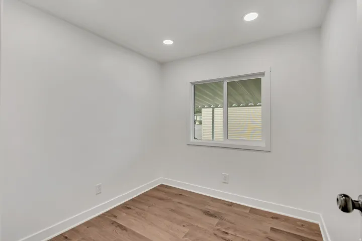 Empty room featuring light wood-type flooring and recessed lighting