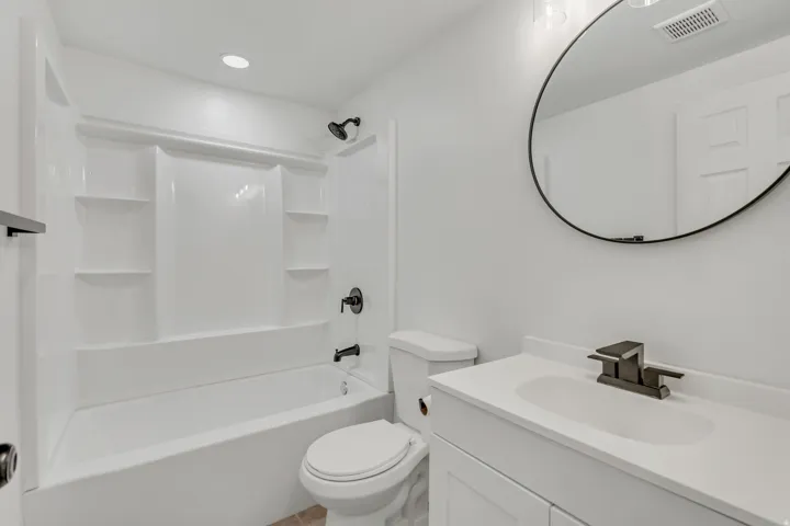 Bathroom with vanity, shower / bathtub combination, and recessed lighting