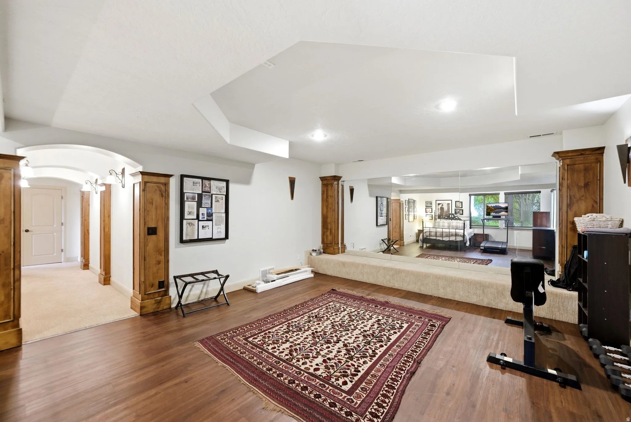 Exercise and dance room, dark wood flooring, and recessed lighting