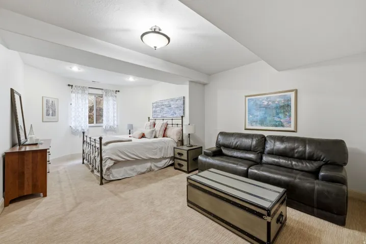 4th bedroom with light carpet with seating area