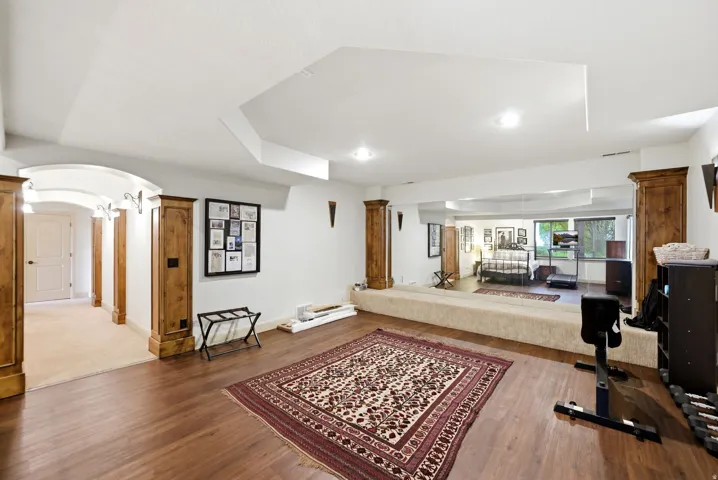 Exercise and dance room, dark wood flooring, and recessed lighting