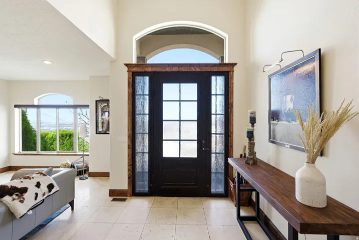 Foyer entrance featuring light tile patterned flooring and baseboards